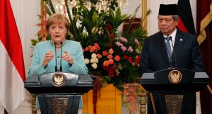 German Chancellor Merkel, accompanied by Indonesian President Yudhoyono, speaks during a news conference after their meeting at the Merdeka Palace in Jakarta